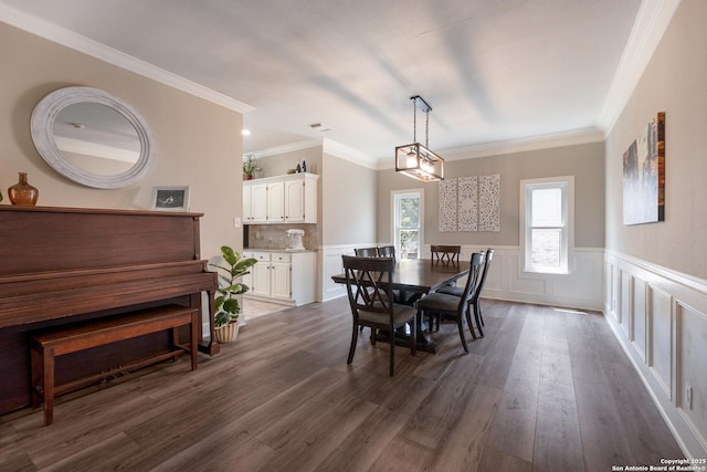 13314 Galicia, Universal City, TX 78148 - dining space featuring dark wood-type flooring, ornamental molding, wainscoting, and a chandelier
