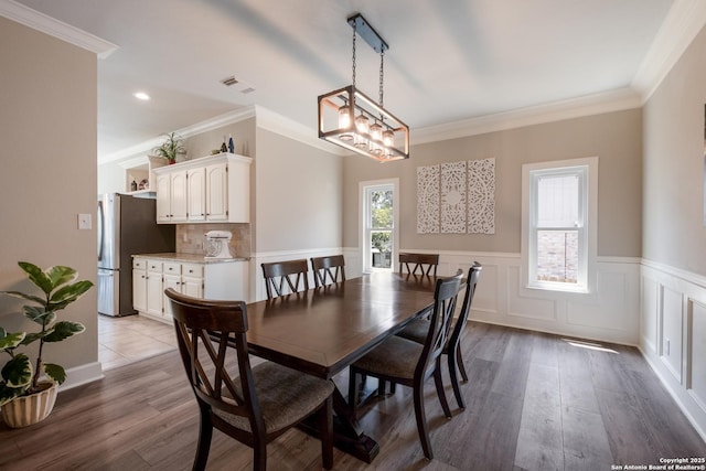 13314 Galicia, Universal City, TX 78148 - dining room featuring wainscoting, ornamental molding, light wood-style flooring, and recessed lighting