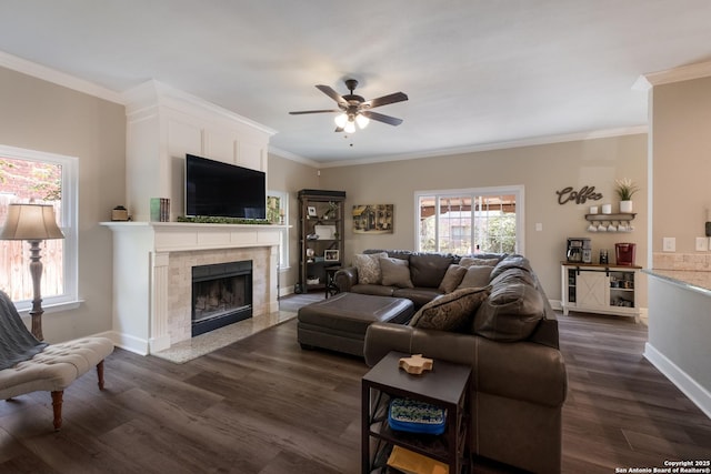 13314 Galicia, Universal City, TX 78148 - living room with a ceiling fan, crown molding, dark wood-type flooring, a tile fireplace, and baseboards