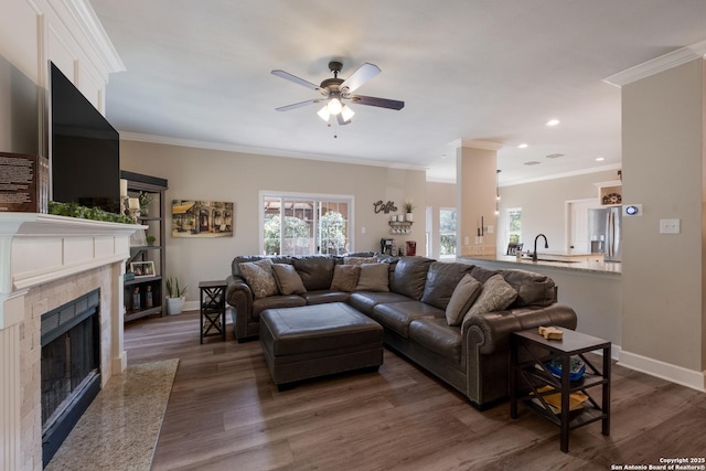 13314 Galicia, Universal City, TX 78148 - living room with a ceiling fan, a high end fireplace, baseboards, ornamental molding, and dark wood finished floors