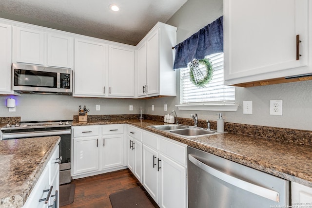 7719 Proton Smt, San Antonio, TX 78252 - kitchen with stainless steel appliances, a sink, white cabinetry, dark wood-style flooring, and recessed lighting