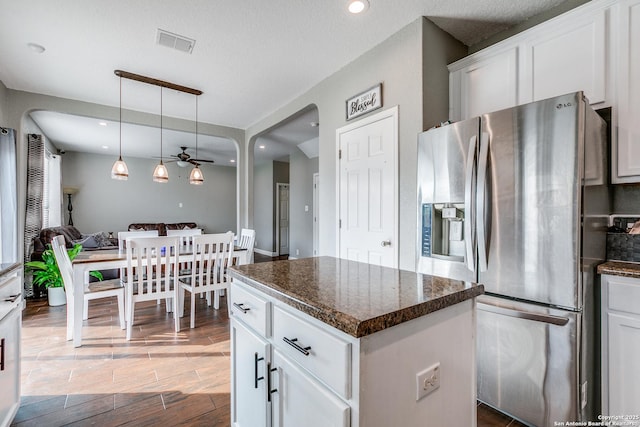 7719 Proton Smt, San Antonio, TX 78252 - kitchen featuring stainless steel fridge, wood finished floors, a center island, white cabinets, and a ceiling fan