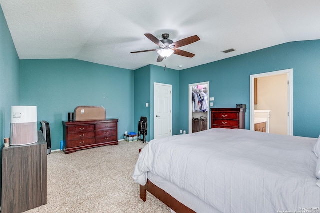 7719 Proton Smt, San Antonio, TX 78252 - carpeted bedroom featuring lofted ceiling, a walk in closet, ceiling fan, a closet, and connected bathroom