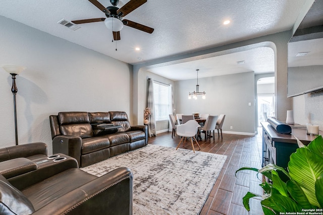 7719 Proton Smt, San Antonio, TX 78252 - living area with a ceiling fan, a chandelier, baseboards, wood tiled floors, and a textured ceiling