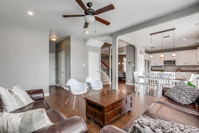 7719 Proton Smt, San Antonio, TX 78252 - living room featuring a ceiling fan, arched walkways, dark wood-type flooring, stairs, and recessed lighting