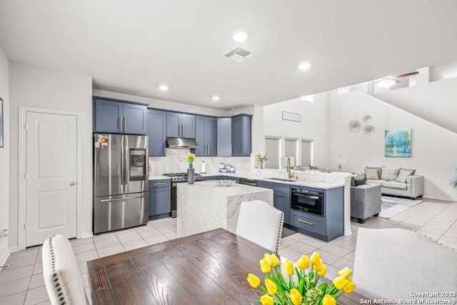 7526 Boxing Elm, San Antonio, TX 78244 - kitchen featuring stainless steel appliances, under cabinet range hood, a sink, a peninsula, and open floor plan