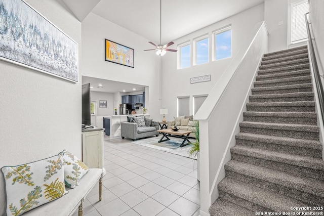 7526 Boxing Elm, San Antonio, TX 78244 - stairs with a ceiling fan, tile patterned flooring, and a high ceiling