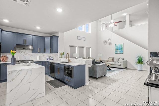 7526 Boxing Elm, San Antonio, TX 78244 - kitchen with a sink, under cabinet range hood, a peninsula, dishwasher, and open floor plan