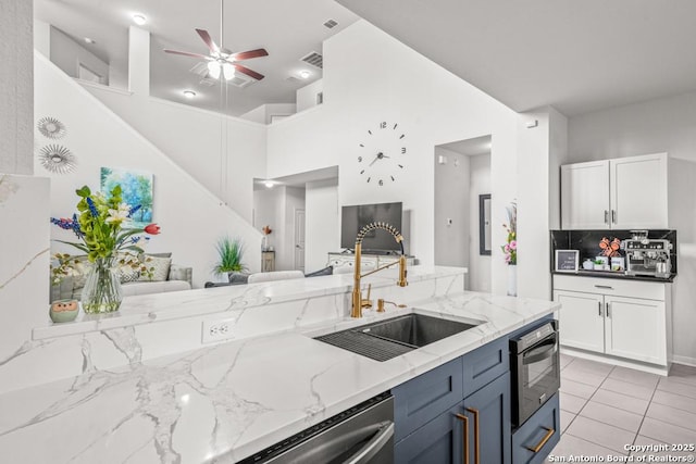 7526 Boxing Elm, San Antonio, TX 78244 - kitchen with a sink, ceiling fan, light stone countertops, open floor plan, and a high ceiling