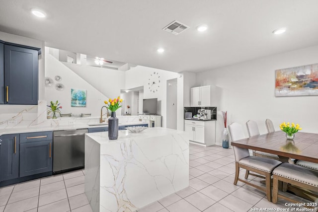 7526 Boxing Elm, San Antonio, TX 78244 - kitchen with stainless steel dishwasher, a peninsula, light tile patterned flooring, light stone counters, and recessed lighting