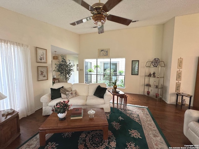 1839 Shoal Run, San Antonio, TX 78232 - living room featuring ceiling fan, a textured ceiling, dark wood-style flooring, and baseboards