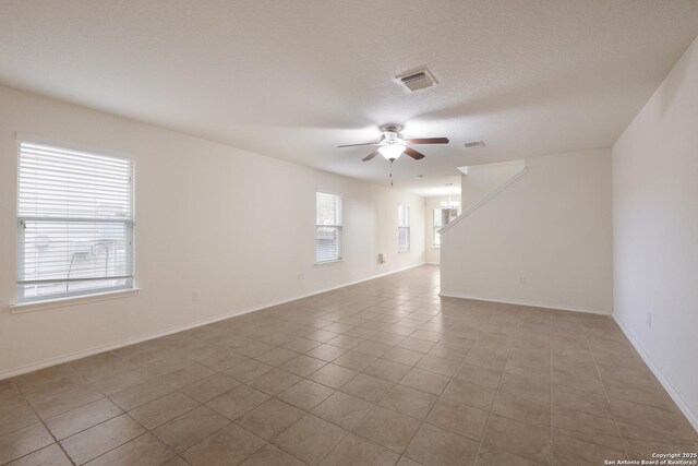 6015 Wisteria Hl, San Antonio, TX 78218 - spare room featuring a ceiling fan, light tile patterned floors, and baseboards