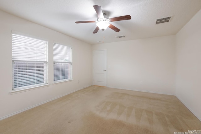6015 Wisteria Hl, San Antonio, TX 78218 - empty room with light colored carpet, ceiling fan, and baseboards