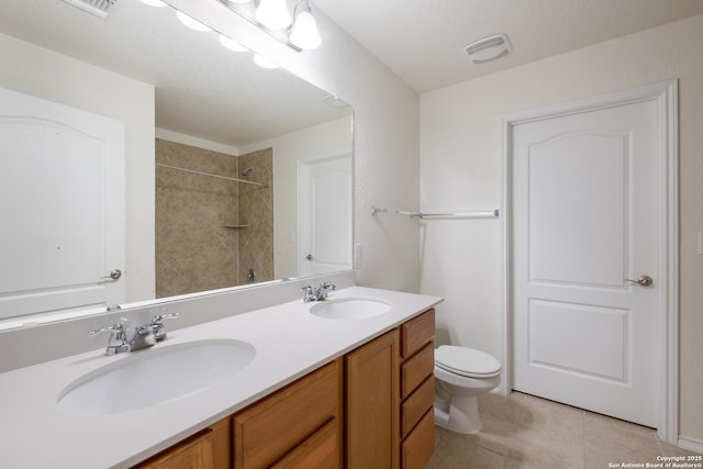 6015 Wisteria Hl, San Antonio, TX 78218 - bathroom featuring tile patterned floors, toilet, a shower, and double vanity