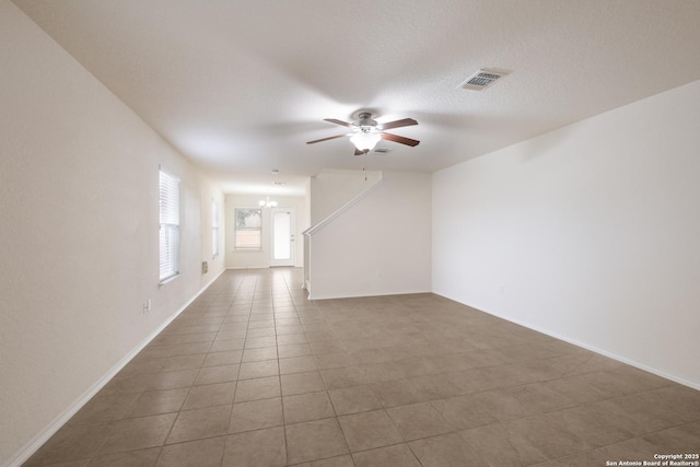 6015 Wisteria Hl, San Antonio, TX 78218 - tiled empty room featuring a chandelier, a ceiling fan, and baseboards
