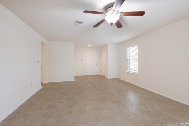 6015 Wisteria Hl, San Antonio, TX 78218 - spare room featuring a ceiling fan, light tile patterned flooring, and baseboards
