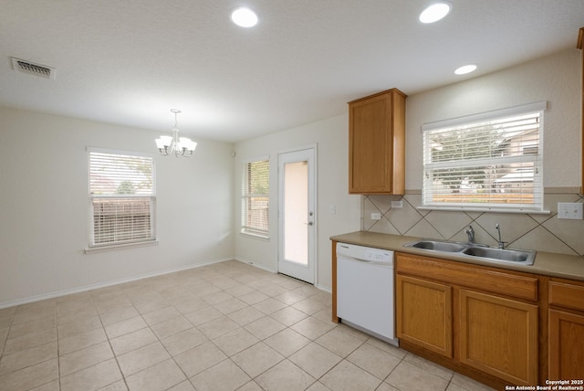 6015 Wisteria Hl, San Antonio, TX 78218 - kitchen with dishwasher, a sink, a chandelier, brown cabinets, and light countertops