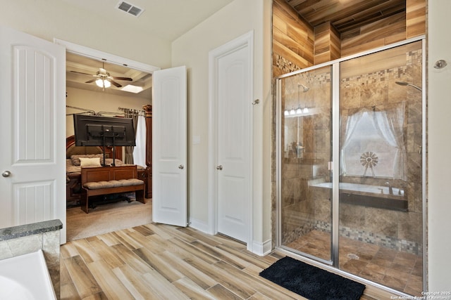 28906 Gracies Sky, San Antonio, TX 78260 - ensuite bathroom featuring a stall shower, wood finished floors, ceiling fan, and baseboards