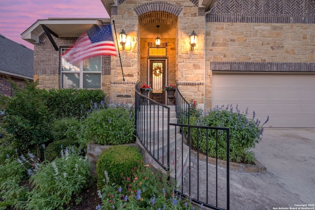 28906 Gracies Sky, San Antonio, TX 78260 - view of exterior entry featuring stone siding, concrete driveway, and an attached garage