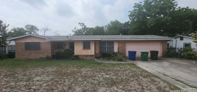 4010 Loop 410, San Antonio, TX 78229 - ranch-style house featuring brick siding, an attached garage, driveway, and a front yard