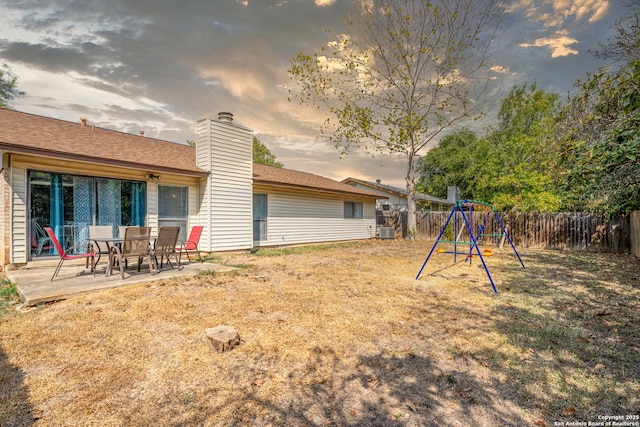 6718 Country Fld, San Antonio, TX 78240 - yard at dusk featuring a playground, a patio, and central AC