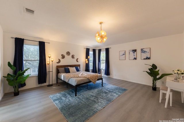 10819 Indigo, San Antonio, TX 78239 - bedroom with wood finished floors, a chandelier, and baseboards