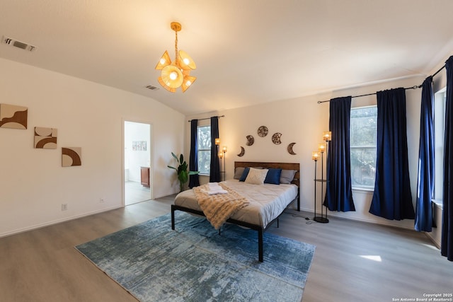 10819 Indigo, San Antonio, TX 78239 - bedroom featuring wood finished floors, a chandelier, lofted ceiling, and baseboards