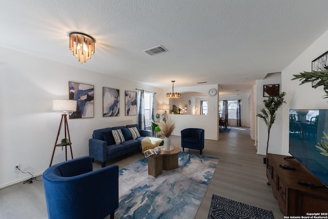 10819 Indigo, San Antonio, TX 78239 - living area with a chandelier, healthy amount of natural light, wood finished floors, and a textured ceiling