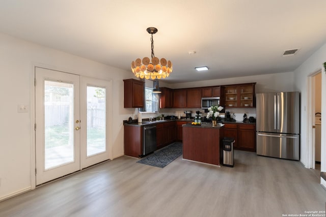 10819 Indigo, San Antonio, TX 78239 - kitchen featuring appliances with stainless steel finishes, dark countertops, french doors, light wood-style floors, and a chandelier