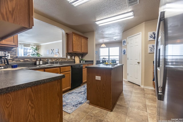 11610 Lemonmint, San Antonio, TX 78245 - kitchen featuring freestanding refrigerator, a sink, dishwasher, dark countertops, and backsplash