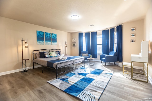 11610 Lemonmint, San Antonio, TX 78245 - bedroom with wood finished floors, baseboards, and a textured ceiling