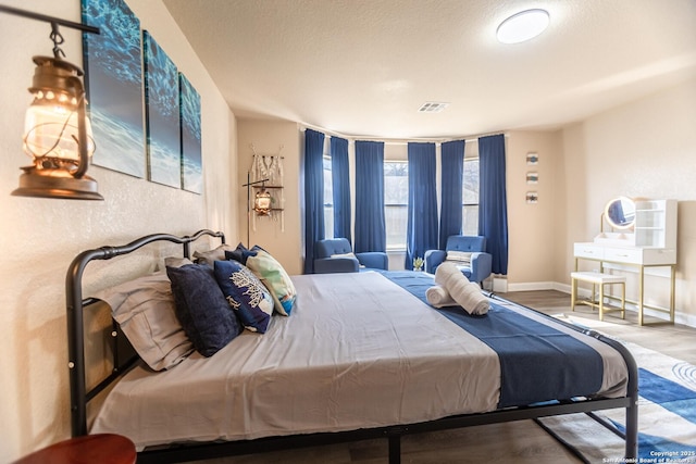 11610 Lemonmint, San Antonio, TX 78245 - bedroom with baseboards, wood finished floors, and a textured wall