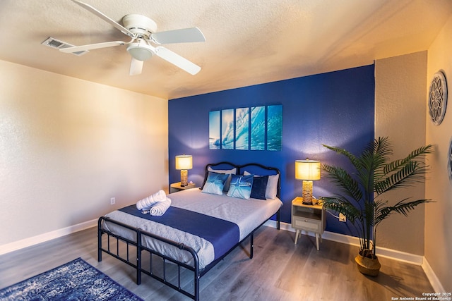 11610 Lemonmint, San Antonio, TX 78245 - bedroom featuring wood finished floors, a textured ceiling, baseboards, and a ceiling fan