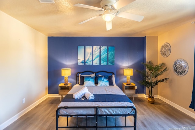 11610 Lemonmint, San Antonio, TX 78245 - bedroom featuring wood finished floors, a textured ceiling, baseboards, and ceiling fan