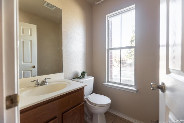 11610 Lemonmint, San Antonio, TX 78245 - half bathroom featuring plenty of natural light, toilet, vanity, and tile patterned flooring