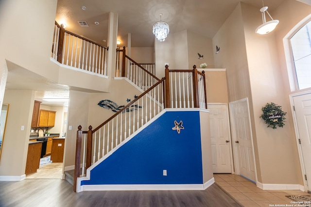 11610 Lemonmint, San Antonio, TX 78245 - staircase with a high ceiling, a chandelier, baseboards, and wood finished floors