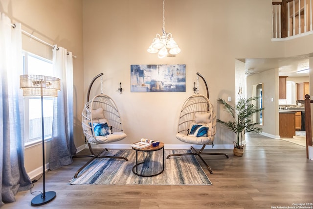 11610 Lemonmint, San Antonio, TX 78245 - sitting room featuring a towering ceiling, a chandelier, wood finished floors, and baseboards