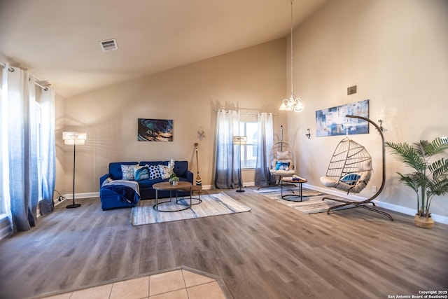 11610 Lemonmint, San Antonio, TX 78245 - living room featuring baseboards, wood finished floors, high vaulted ceiling, and a chandelier