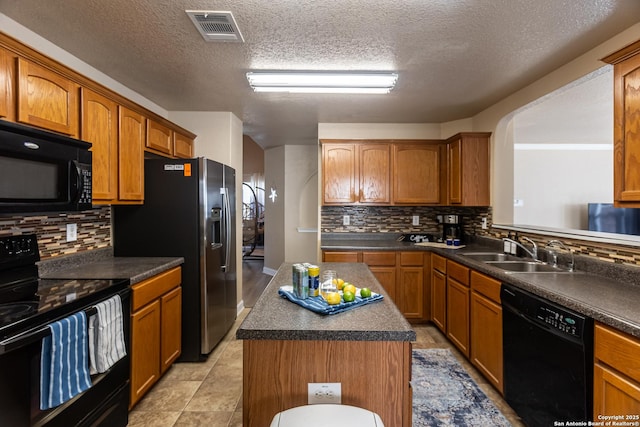 11610 Lemonmint, San Antonio, TX 78245 - kitchen with black appliances, a sink, decorative backsplash, dark countertops, and a textured ceiling