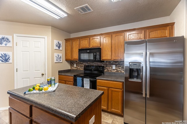 11610 Lemonmint, San Antonio, TX 78245 - kitchen with black appliances, dark countertops, decorative backsplash, light tile patterned flooring, and brown cabinetry