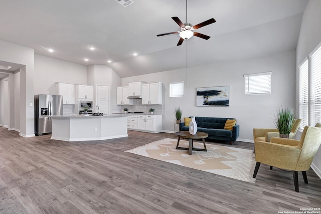 513 Foxbrook, Cibolo, TX 78108 - living room with ceiling fan, wood finished floors, baseboards, recessed lighting, and high vaulted ceiling