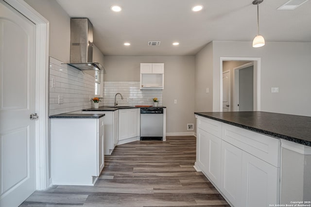 2411 W Huisache Ave, San Antonio, TX 78228 - kitchen featuring dishwashing machine, wall chimney exhaust hood, dark countertops, a sink, and recessed lighting