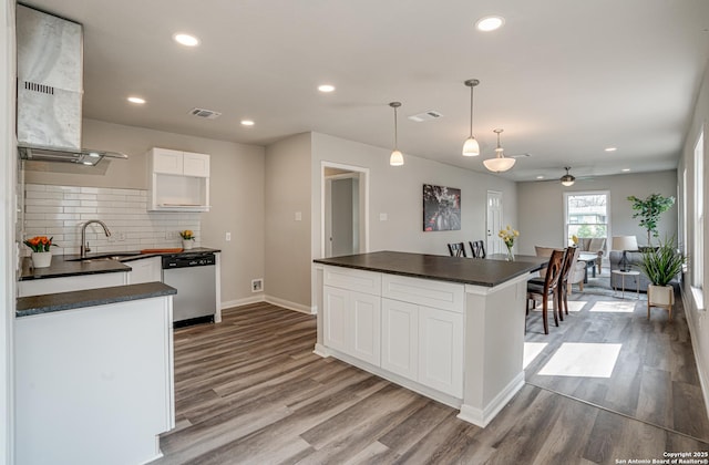 2411 W Huisache Ave, San Antonio, TX 78228 - kitchen featuring dishwasher, dark countertops, a sink, wood finished floors, and recessed lighting