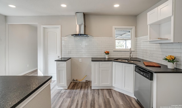 2411 W Huisache Ave, San Antonio, TX 78228 - kitchen with a sink, wall chimney range hood, dishwasher, light wood finished floors, and decorative backsplash