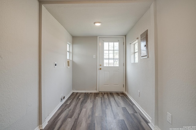2411 W Huisache Ave, San Antonio, TX 78228 - doorway to outside with dark wood finished floors, baseboards, and a textured wall