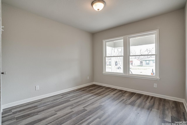 2411 W Huisache Ave, San Antonio, TX 78228 - unfurnished room featuring dark wood-type flooring and baseboards