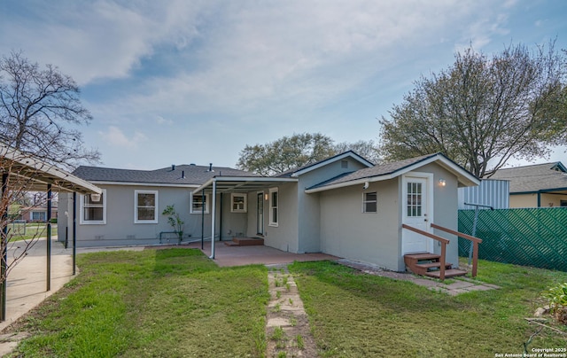 2411 W Huisache Ave, San Antonio, TX 78228 - rear view of house featuring a patio, entry steps, stucco siding, and a shingled roof