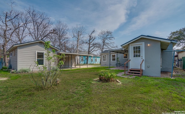 2411 W Huisache Ave, San Antonio, TX 78228 - rear view of property featuring entry steps and a yard