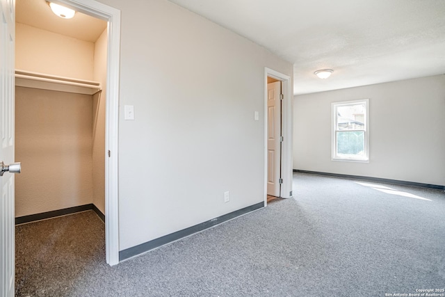 2411 W Huisache Ave, San Antonio, TX 78228 - unfurnished bedroom with baseboards, carpet floors, and a spacious closet