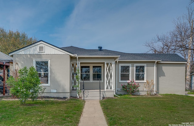 2411 W Huisache Ave, San Antonio, TX 78228 - view of front facade featuring a front lawn, stucco siding, and a shingled roof